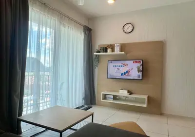 a living room with a tv and a table at Onsen Premium Hotspring Suite Sunway Tambun Ipoh in Tambun