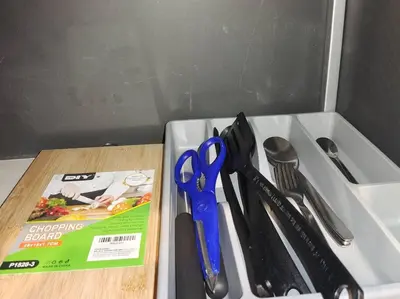a cutting board with a pair of scissors and a magazine at \u3010NEW\u3011Modern Comfort Studio@Juru Sentral Icon City in Bukit Mertajam