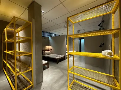 a room with yellow bunk beds and a couch at M-Stay Hostel in Chemor