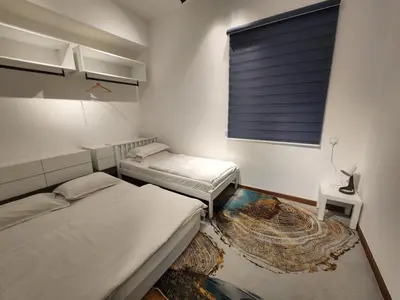 two beds in a room with a window and a rug at Beacon Executive Suite - Skypool Penang View in George Town
