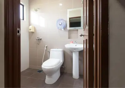 a bathroom with a toilet and a sink at Hotel Pulai Ipoh in Ipoh