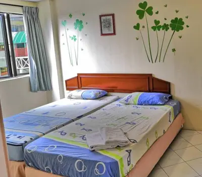 a bedroom with two twin beds in it at Affordable Cozy Apartment @ Coral Bay Resort in Pasir Bogak