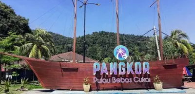 a large wooden boat with a sign on it at Affordable Cozy Apartment @ Coral Bay Resort in Pasir Bogak