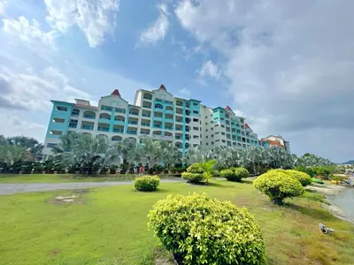 a large building with a park in front of it at AnyLodge Waterfront Marina Island Pangkor-Lumut in Lumut
