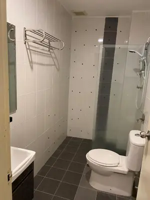 a bathroom with a toilet and a shower and a sink at AnyLodge Waterfront Marina Island Pangkor-Lumut in Lumut