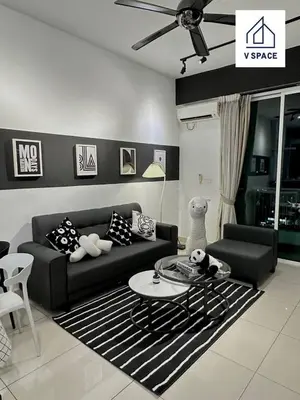 a living room with a black couch and a table at Ipoh D Festivo Suites 6-10pax 10mins to Sunway Tambun by IWH in Ipoh