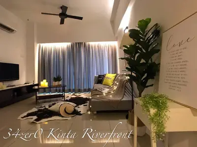 a living room with a couch and a tv at 34zer0 Kinta Riverfront Suites 6pax in Ipoh