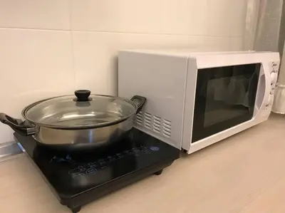 a microwave oven with a pot on top of it at 34zer0 Kinta Riverfront Suites 6pax in Ipoh