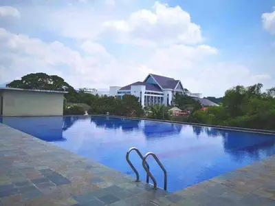 a swimming pool with two metal statues in the water at 34zer0 Kinta Riverfront Suites 6pax in Ipoh