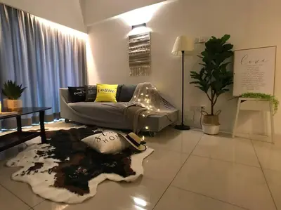 a living room with a couch and a rug at 34zer0 Kinta Riverfront Suites 6pax in Ipoh