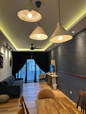 a living room with two lights and a table at Adik Aisyah Black forest Cameron Highlands homestay For Muslim in Cameron Highlands