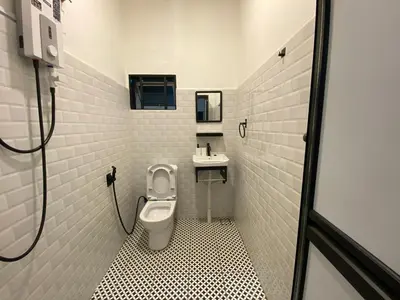 a bathroom with a toilet and a sink at Dudu Guesthouse Ipoh in Ipoh
