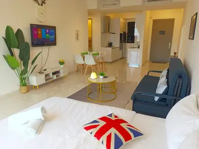 a room with a bed and a living room at Rooftop Pool, 8 Pax, 2 Bedrooms, 2 Bathrooms, 2 Car Parks by Star Home in Jelutong