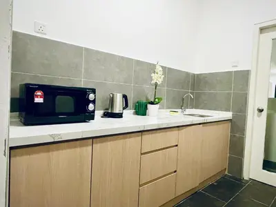 a kitchen with a microwave sitting on a counter at The Cove Hillside@Loft in Ipoh