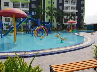 a swimming pool with a playground in a building at Ipoh Waterpark Pool View Homestay in Ipoh