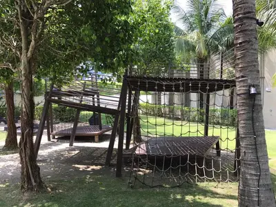 a cage with a bench next to a tree at By The Sea@Side Seaview n Side Pool view (C3A3A) in Batu Ferringhi