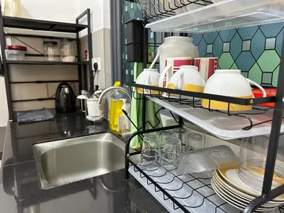 a kitchen with a sink and a shelf with dishes at Spacious 3BR I Meritus Perai l Family & Nice View in Perai