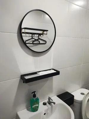 a bathroom with a mirror and a sink and a toilet at 7&9 Manhattan Condominium Ipoh in Ipoh