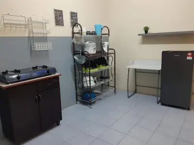a kitchen with a sink and a refrigerator at Ammar Homestay Gua Musang in Gua Musang