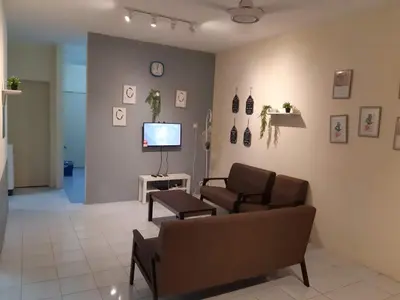 a living room with a couch and a tv at Ammar Homestay Gua Musang in Gua Musang