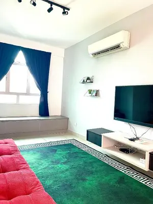 a living room with a red couch and a flat screen tv at Spice Arena Guesthouse in Bayan Lepas