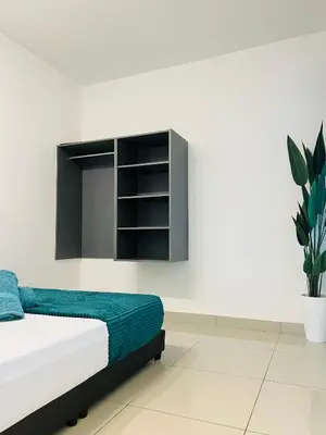 a bedroom with a bed and a plant at Spice Arena Guesthouse in Bayan Lepas
