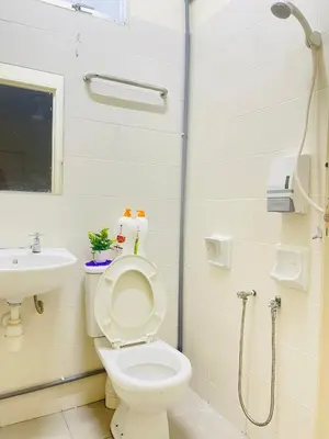 a bathroom with a toilet and a sink at Spice Arena Guesthouse in Bayan Lepas