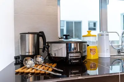 a kitchen counter with a coffee maker and cookies at Sunrise Terrace at Quintet (3BR/8 pax) in Tanah Rata