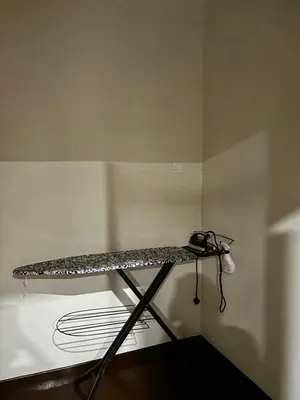a shelf in the corner of a room at Homestay Hajrah in Ipoh
