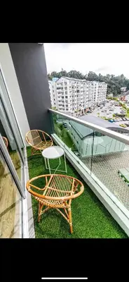a balcony with a table and chairs on a building at City Retreat at Quintet(3BR/8pax) 9 Jalan PMCJ, Tanah Rata in Tanah Rata