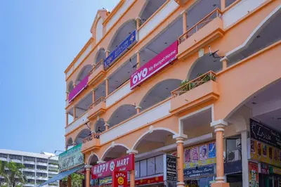 a building with many signs on the side of it at Hotel O My Budget Home in Batu Ferringhi
