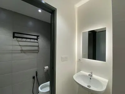 a bathroom with a sink and a toilet and a mirror at JOVIAL Modern Cozy Suite `Metropol BM BandarPerda in Bukit Mertajam