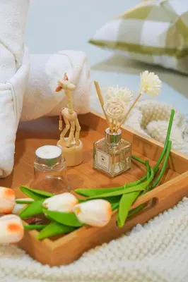 a wooden tray with flowers and a bottle of perfume at The Octagon Ipoh -- In the Heart of the City in Ipoh