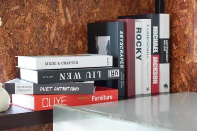 a stack of books sitting on a shelf at The Octagon Ipoh -- In the Heart of the City in Ipoh