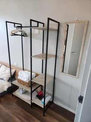 a black shelving unit in a room with a mirror at Unique Boho Style Condo with NETFLIX for up to 5PAX - Enjoy Mountain View while swimming at the Infinity Pool & Natural Hotspring Pool, 2mins walk to the Lost World of Tambun, Water Themepark at IPOH in Ipoh