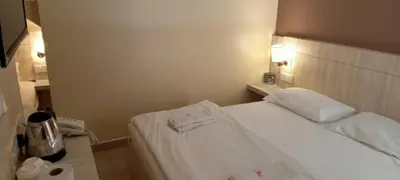 a hotel room with a bed with a towel on it at Spring Inn Hotel in Sungai Petani