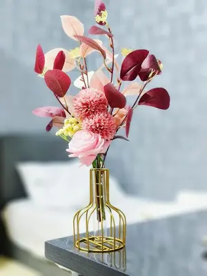 a vase with flowers in it on a table at Cozy n Quiet home near to BKE Highway n Kulim High Tech Park in Lunas