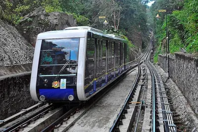 a blue and white train on the tracks at AAA Homestay Georgetown Penang in Ayer Itam