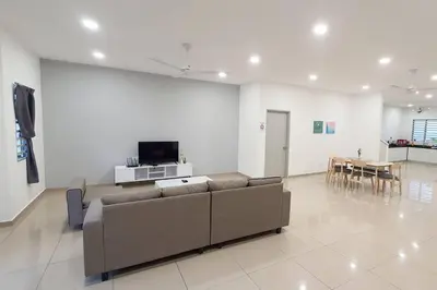 a living room with a couch and a table at JOVIAL COZY&STYLISH 2STORYHOUSE 4ROOM@BMJURU in Bukit Mertajam