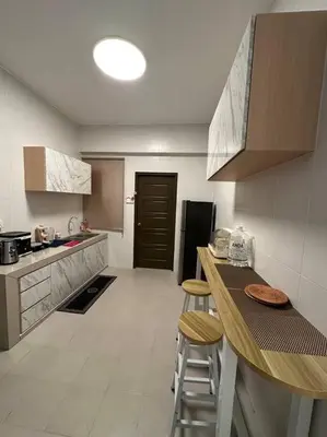 a kitchen with a counter and two stools in it at Ulike Homestay-3Room-4 king Size Bed-The Venus in Sitiawan