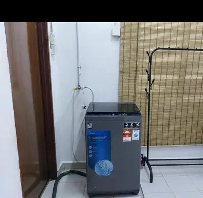 a trash can sitting in the corner of a room at SEROJA HOMESTAY in Baling