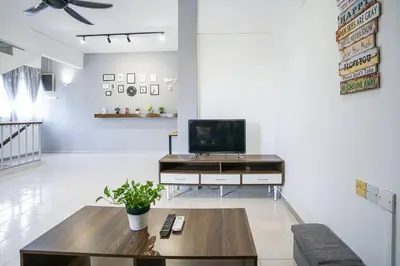 a living room with a tv and a coffee table at Jovial Modern Stylish Townhouse 8pax - BM Icon City in Bukit Mertajam