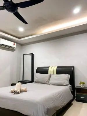 a bedroom with a bed with a ceiling fan at Modern Stylish Double Storey 5Room 9Pax @Icon city in Bukit Mertajam