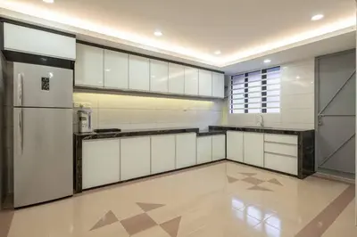 a large kitchen with white cabinets and a refrigerator at Modern Stylish Double Storey 5Room 9Pax @Icon city in Bukit Mertajam