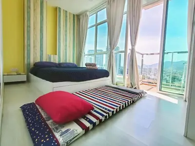 a bedroom with two beds and a large window at Deluxe Suites 2, Netflix ,2-5 pax, Georgetown in George Town