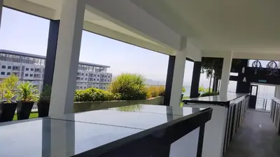 a balcony with two tables and a view of a building at Urban Suites JSW GEORGETOWN PENANG, MALAYSIA in Jelutong