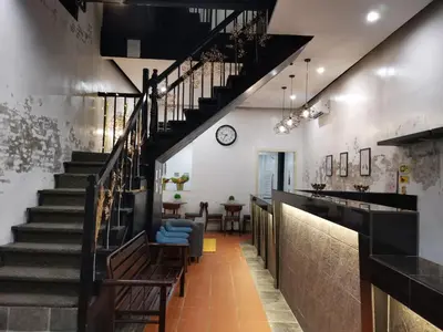 a hallway with stairs leading up to a dining room at G FORTUNE GUEST HOUSE+ in George Town