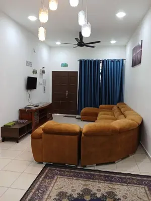 a living room with a large couch and a tv at D'tasek Homestay Gua Musang in Gua Musang