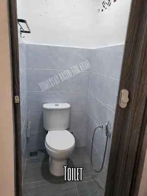 a bathroom with a toilet and a shower at Homestay Kasih Tok Ayah Sg Petani in Sungai Petani