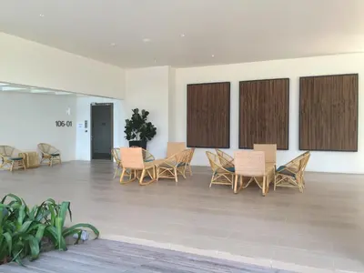 a group of chairs and tables in a room at By The Sea Cozy Beachfront Home Side Seaview333A in Batu Ferringhi
